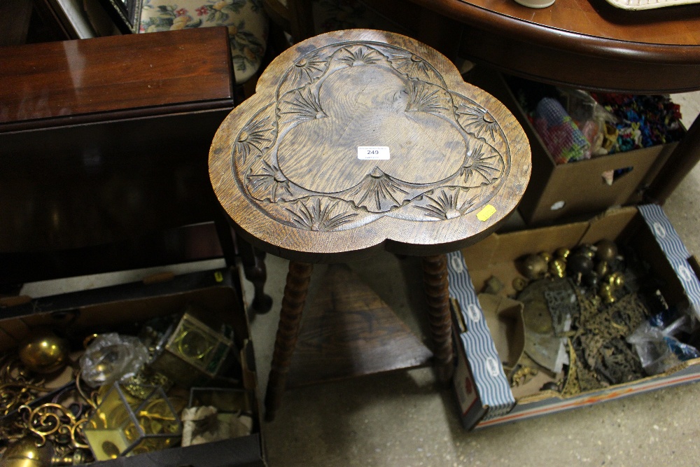 An oak clover leaf topped occasional table raised