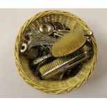 A circular wicker basket containing silver plated