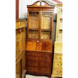 A reproduction mahogany bureau bookcase fitted fou