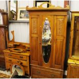 A late Victorian satinwood single door wardrobe; a