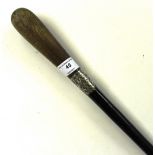 An ebonised walking cane with white metal collar