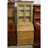 A stripped pine bureau bookcase fitted three long