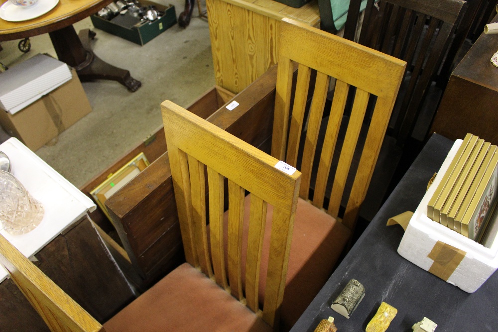 A set of six light oak slat back dining chairs