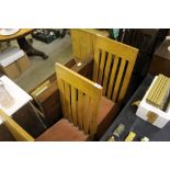 A set of six light oak slat back dining chairs