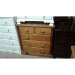 A stripped pine chest fitted two short over three