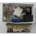 A box containing glass paperweights and various co