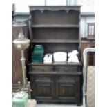 An oak linen fold decorated two drawer dresser