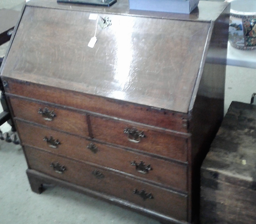 An 18th Century oak bureau fitted two short over t