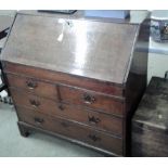 An 18th Century oak bureau fitted two short over t