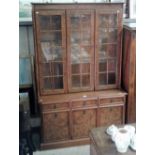 A Nathan walnut effect cabinet raised on cupboard