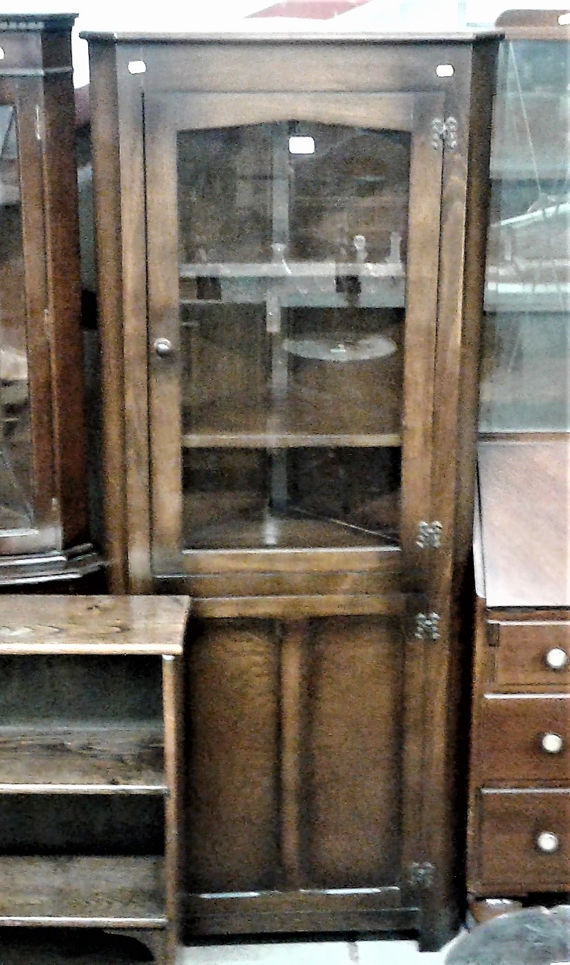 An oak and gazed upright corner cabinet