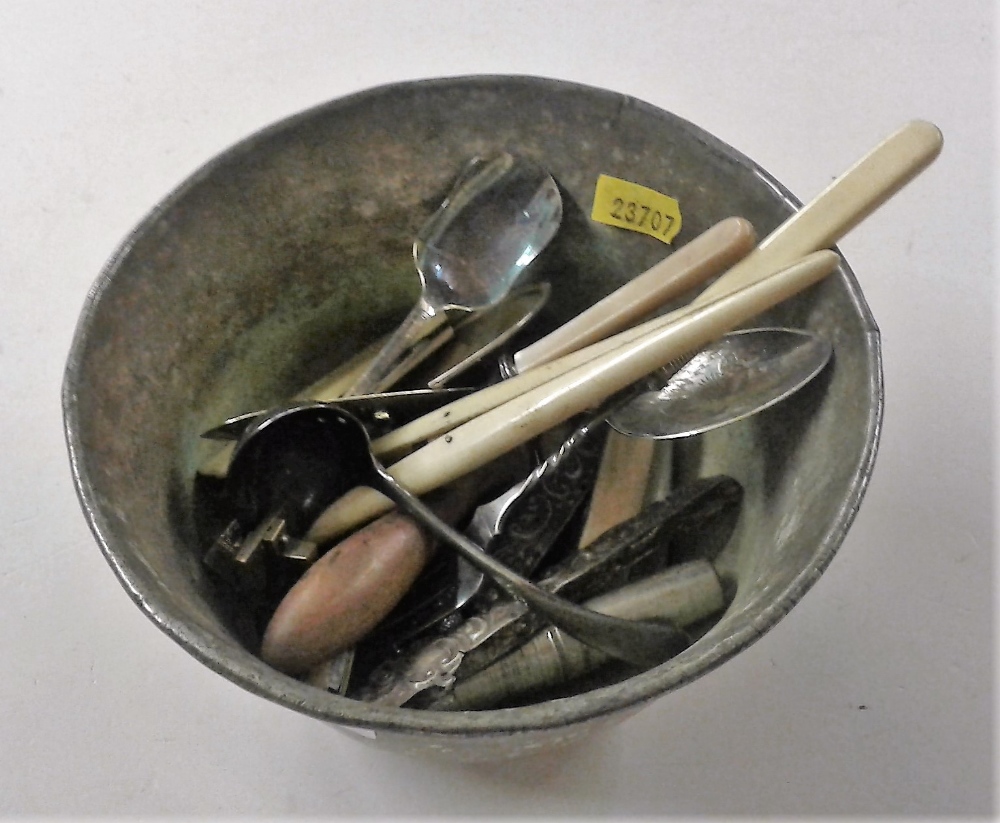 A copper bowl of various cutlery; glove stretchers