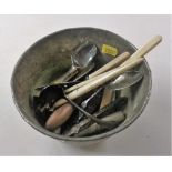 A copper bowl of various cutlery; glove stretchers