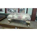 A gilded wooden and floral upholstered stool
