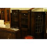 An oak and glazed upright corner cabinet