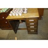 An oak single pedestal desk fitted four drawers