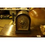 A Tempus Fugit oak cased single hole mantel clock