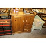 A pine side cupboard fitted two drawers