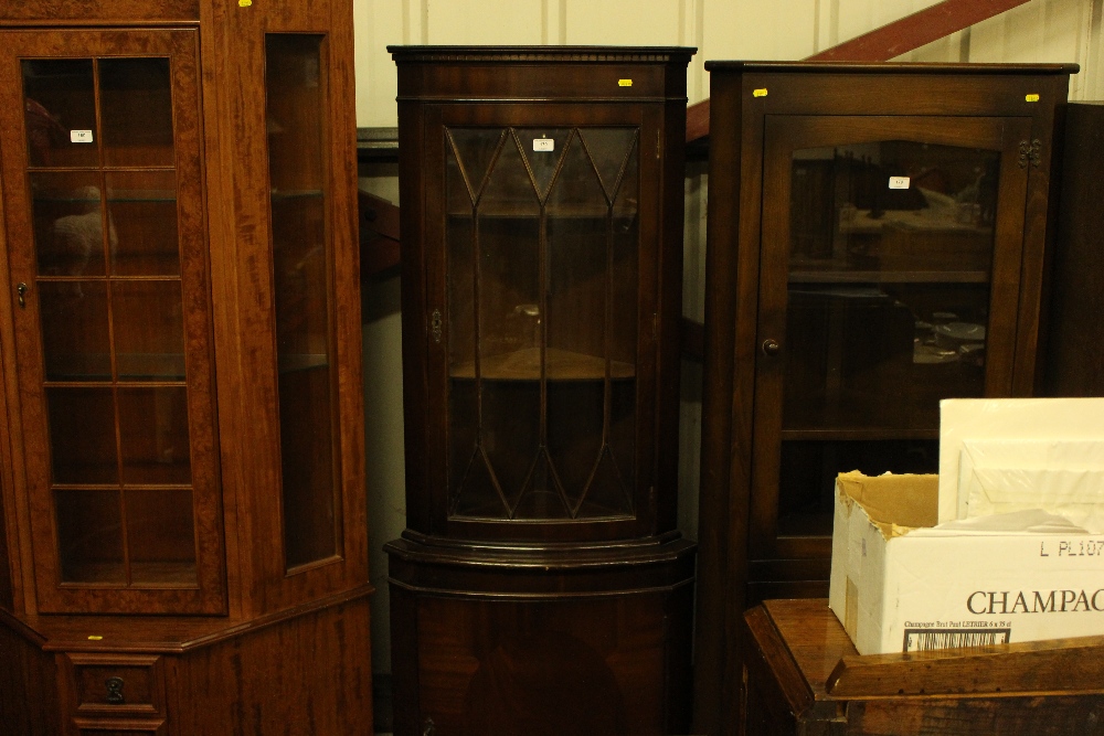 A reproduction mahogany and glazed corner cabinet