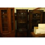 A reproduction mahogany and glazed corner cabinet