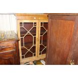 A mahogany and glazed cabinet on stand