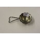 A silver tea strainer