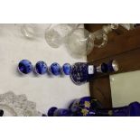 A blue glass and white metal over laid liqueur set