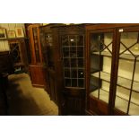 An oak and leaded glazed corner cabinet