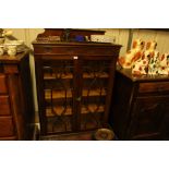 An Edwardian mahogany and bevelled glass display c