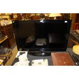 An Alba 4011 flat screen television with remote con