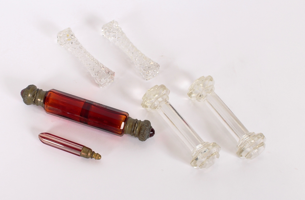 A Victorian ruby glass double ended scent bottle; a small ruby and clear glass scent phial; and
