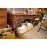 An oak writing desk with brown leather inset top,