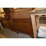 An oak three drawer bureau