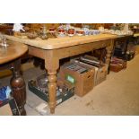 A stripped pine kitchen table