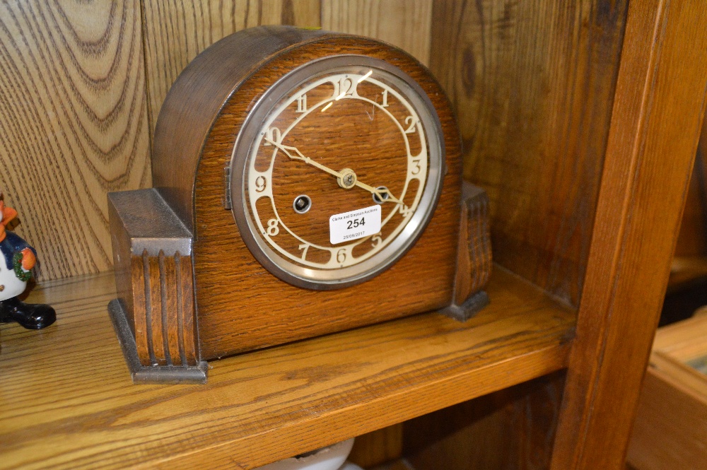 A 1930's oak two hole mantel clock