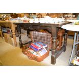 An oak veneered draw leaf dining table