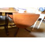 A reproduction mahogany drop leaf dining table