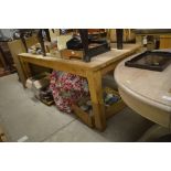 A large stripped pine kitchen table