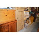 A Victorian stripped pine cupboard of narrow propo