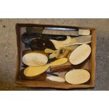 A box of various dressing table brushes and mirror