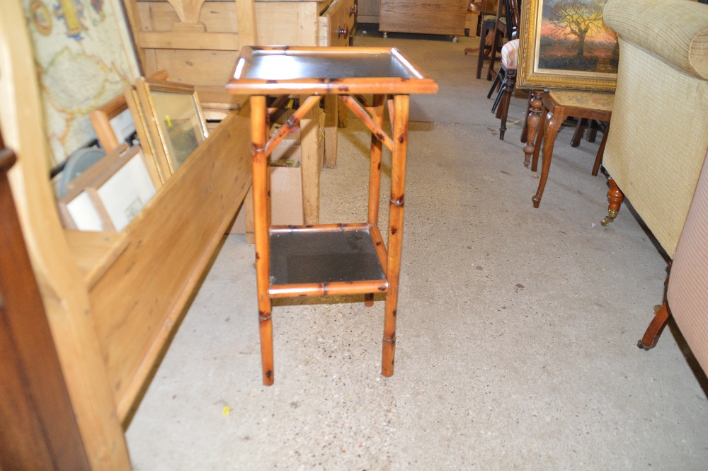 A bamboo and black lacquered two tier table