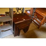 A nest of three hardwood occasional tables