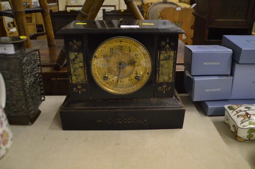 An early 20th Century metal cased two hole mantel