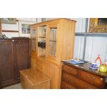 A large light oak and glazed dresser fitted four d