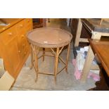 A rattan and bamboo circular topped table