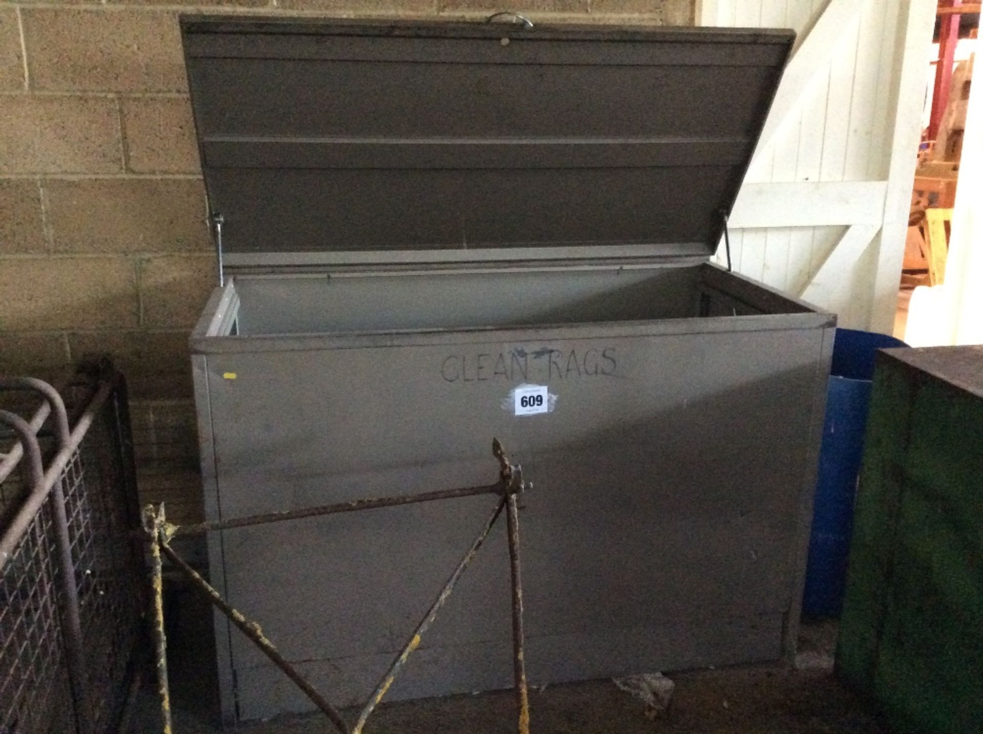 Large metal bin with quantity of rag.