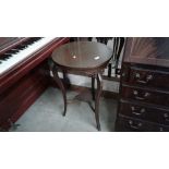 A mahogany circular topped table