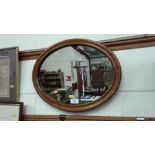 A Victorian oval mahogany wall mirror