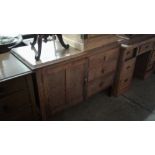 An oak three drawer sideboard