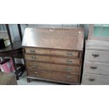 A Georgian oak and inlaid bureau fitted four long